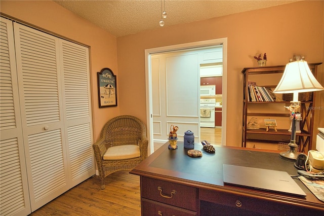 home office with a textured ceiling and wood finished floors