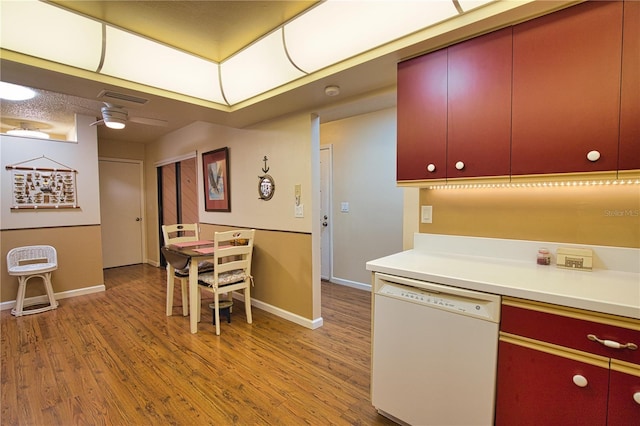 kitchen with visible vents, red cabinets, dishwasher, and light wood finished floors