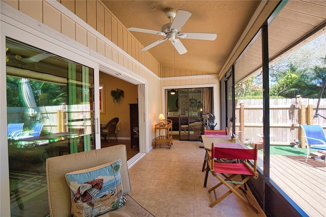 sunroom / solarium featuring vaulted ceiling and ceiling fan