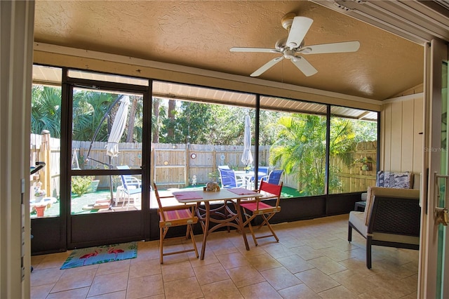 sunroom featuring lofted ceiling and ceiling fan