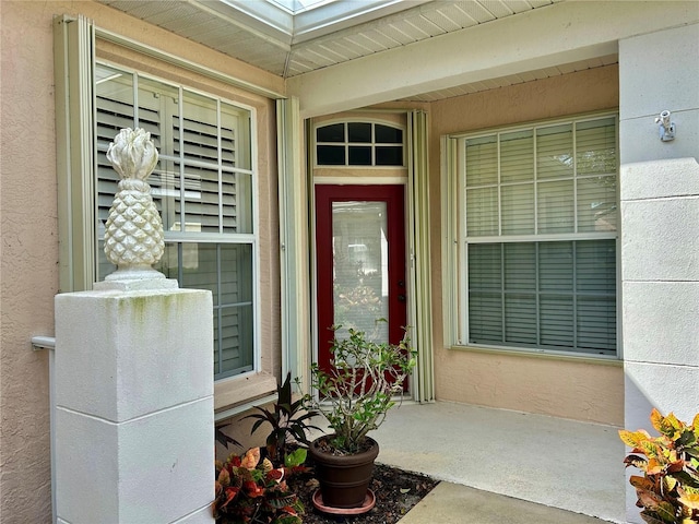 property entrance with stucco siding