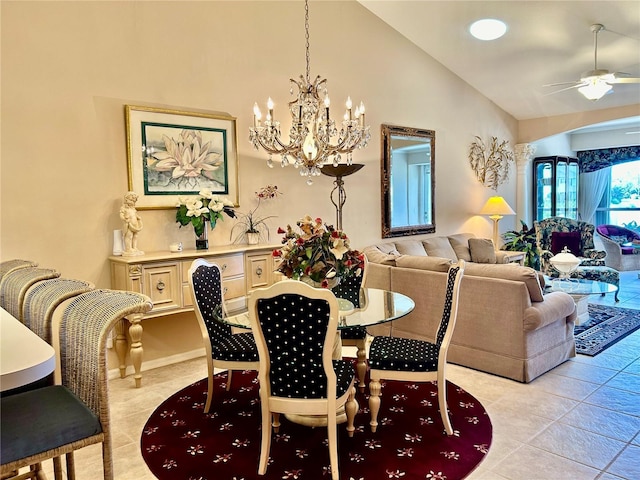 dining room featuring light tile patterned floors, ceiling fan with notable chandelier, and high vaulted ceiling