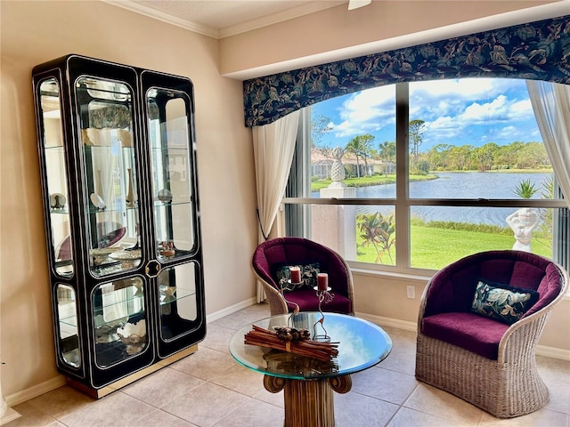 sitting room featuring a water view, baseboards, and ornamental molding