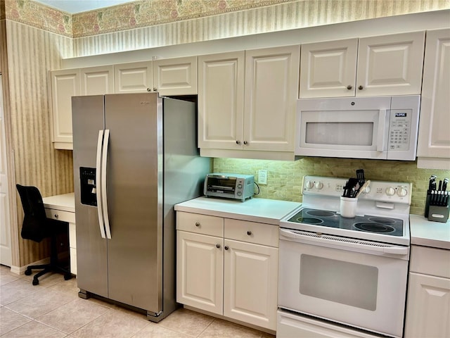 kitchen with white appliances, a toaster, light tile patterned flooring, decorative backsplash, and light countertops