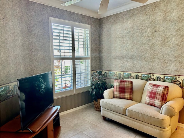 sitting room featuring wallpapered walls, a ceiling fan, baseboards, and ornamental molding