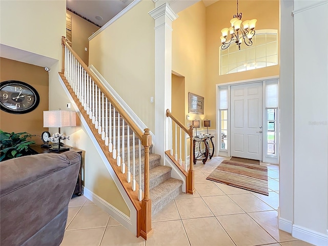 23901 Waverly Cir, Venice, FL 34293 - foyer entrance featuring a towering ceiling, a chandelier, stairway, light tile patterned flooring, and baseboards