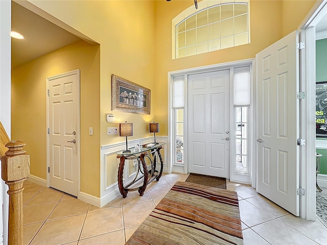 23901 Waverly Cir, Venice, FL 34293 - entryway with light tile patterned floors, a towering ceiling, and baseboards