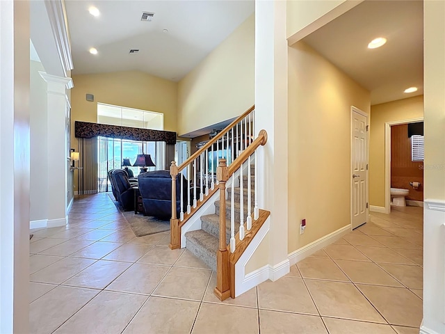 23901 Waverly Cir, Venice, FL 34293 - stairway featuring tile patterned floors, ornate columns, baseboards, vaulted ceiling, and recessed lighting