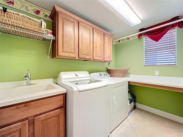 23901 Waverly Cir, Venice, FL 34293 - washroom with washing machine and clothes dryer, cabinet space, and light tile patterned floors