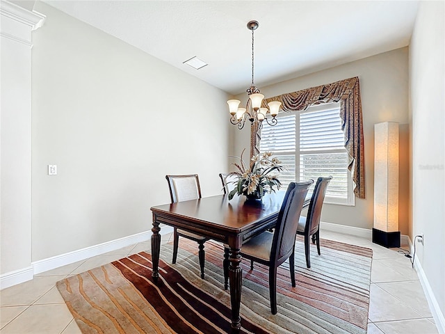 23901 Waverly Cir, Venice, FL 34293 - dining area featuring light tile patterned floors, a chandelier, and baseboards