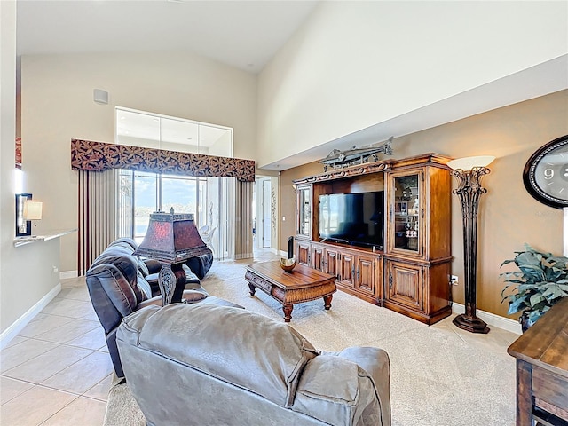 23901 Waverly Cir, Venice, FL 34293 - living area with light tile patterned flooring, high vaulted ceiling, and baseboards