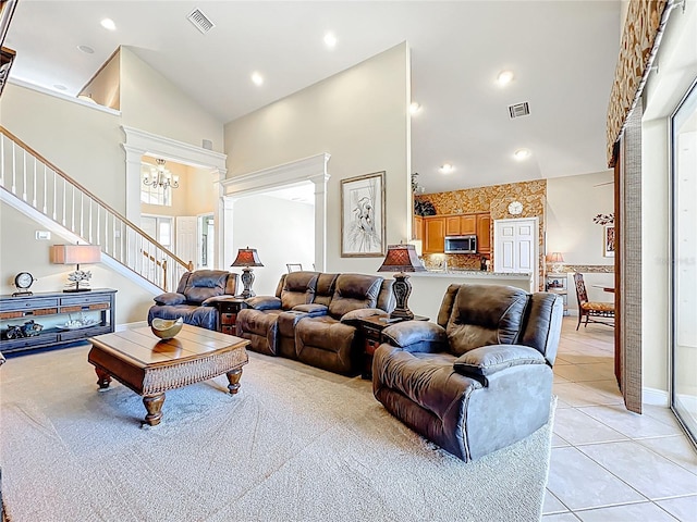 23901 Waverly Cir, Venice, FL 34293 - living room featuring high vaulted ceiling, stairway, light tile patterned floors, and a chandelier