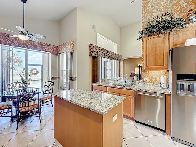 23901 Waverly Cir, Venice, FL 34293 - kitchen featuring appliances with stainless steel finishes, a sink, light tile patterned flooring, and a ceiling fan