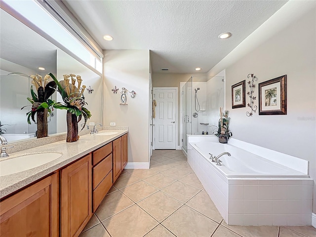 23901 Waverly Cir, Venice, FL 34293 - bathroom featuring a bath, double vanity, a textured ceiling, tile patterned floors, and a stall shower