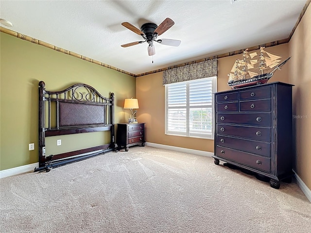 23901 Waverly Cir, Venice, FL 34293 - bedroom with light carpet, baseboards, a ceiling fan, and a textured ceiling