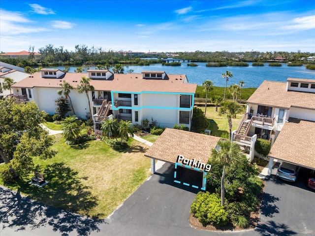 birds eye view of property featuring a water view and a residential view