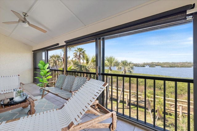 sunroom / solarium with lofted ceiling, a healthy amount of sunlight, a water view, and ceiling fan