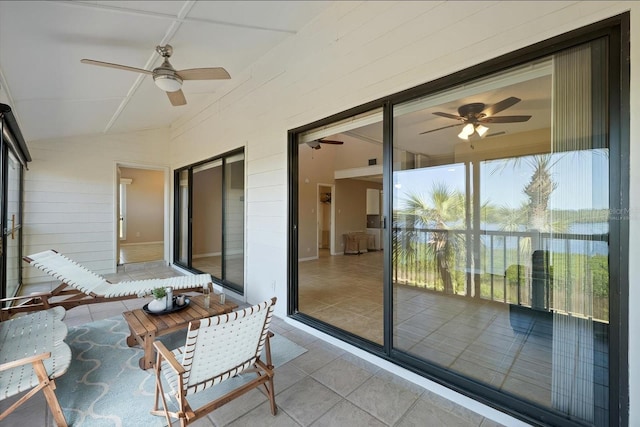 sunroom / solarium featuring lofted ceiling and ceiling fan