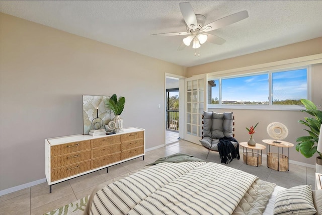 bedroom with tile patterned floors, a textured ceiling, and baseboards