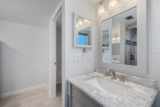 bathroom featuring visible vents, vanity, and baseboards