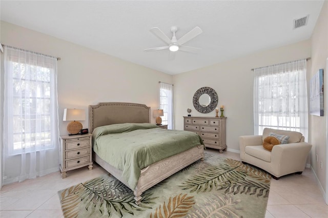 bedroom featuring light tile patterned floors, visible vents, and multiple windows