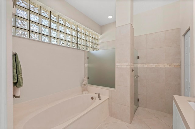 full bath with tile patterned floors, a bath, and walk in shower