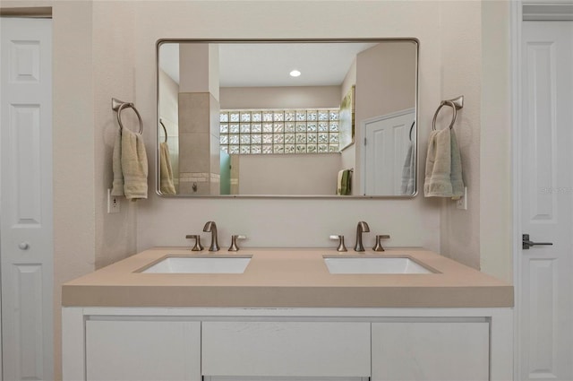 full bathroom featuring a sink and double vanity