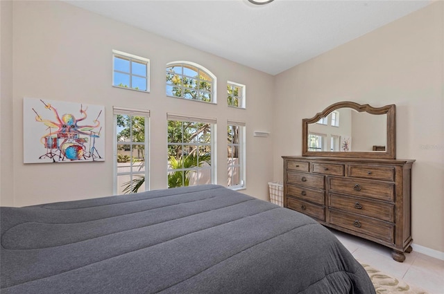 bedroom featuring light tile patterned floors and baseboards