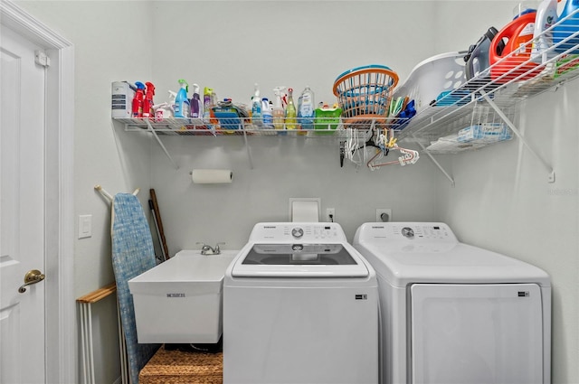 laundry room with a sink, laundry area, and washer and dryer