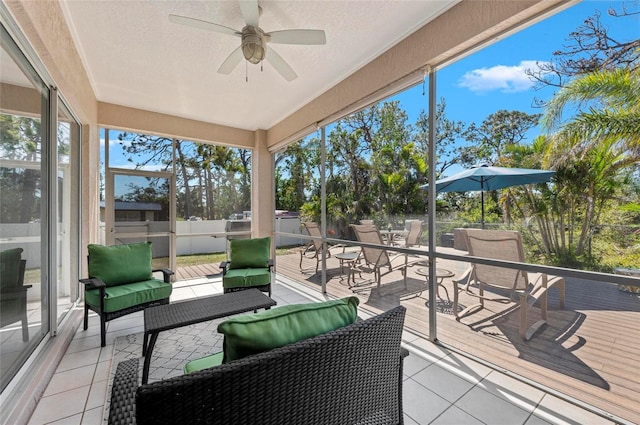 sunroom with a ceiling fan