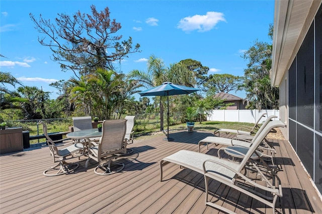 deck with outdoor dining area and fence