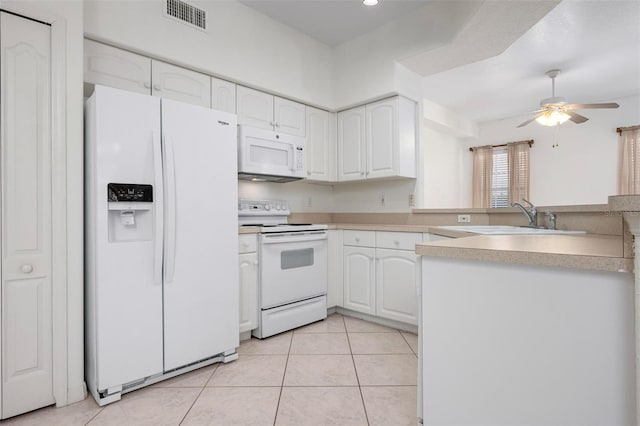 kitchen with a ceiling fan, a sink, white cabinetry, white appliances, and light tile patterned floors