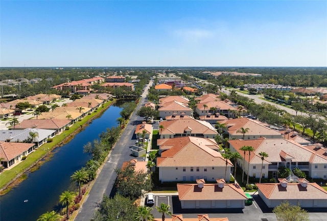 drone / aerial view with a residential view and a water view