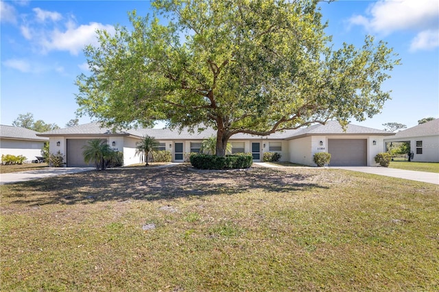 single story home featuring stucco siding, driveway, an attached garage, and a front yard