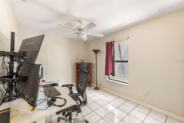 office featuring light tile patterned floors, baseboards, and ceiling fan