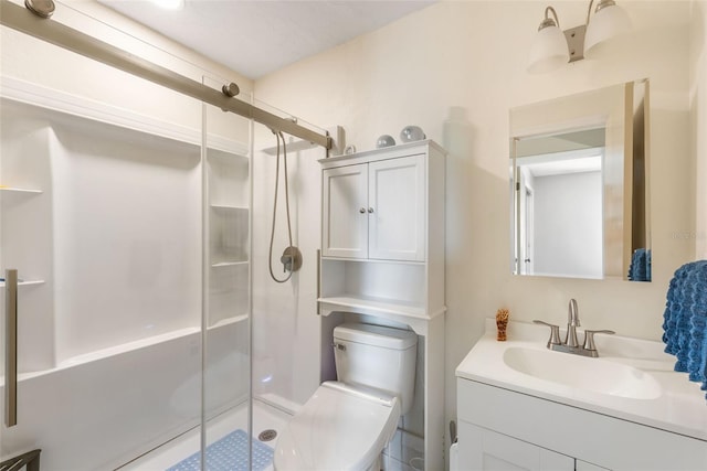 bathroom with a stall shower, toilet, and vanity