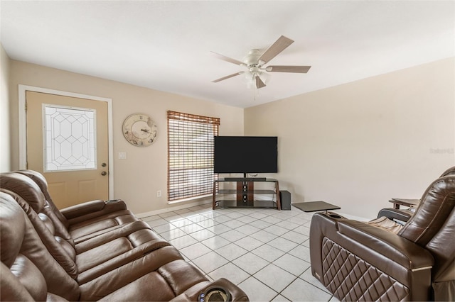 living room featuring light tile patterned floors, baseboards, and a ceiling fan