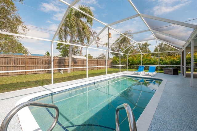 view of swimming pool featuring a fenced in pool, a patio, a fenced backyard, and glass enclosure