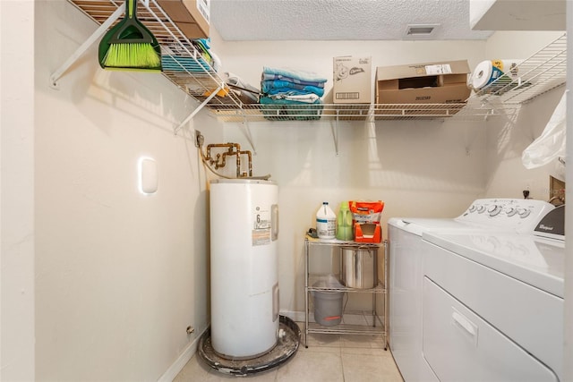 laundry room with independent washer and dryer, electric water heater, a textured ceiling, light tile patterned flooring, and laundry area