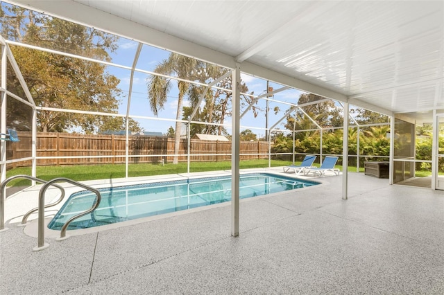 view of swimming pool featuring a patio, a fenced backyard, a fenced in pool, and a lanai