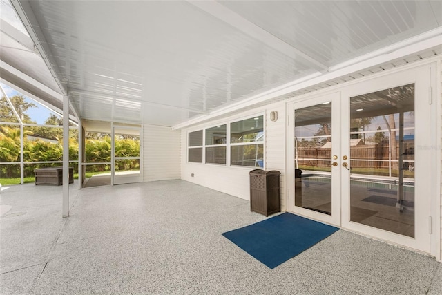 unfurnished sunroom with french doors