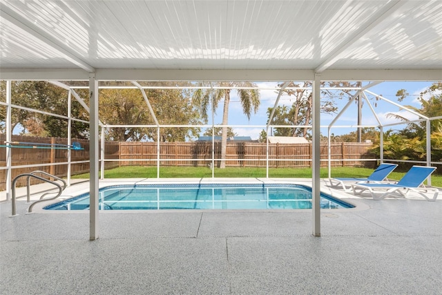 view of swimming pool with a lanai, a patio, and a fenced backyard