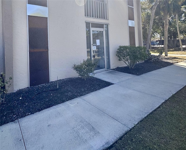 view of exterior entry with stucco siding