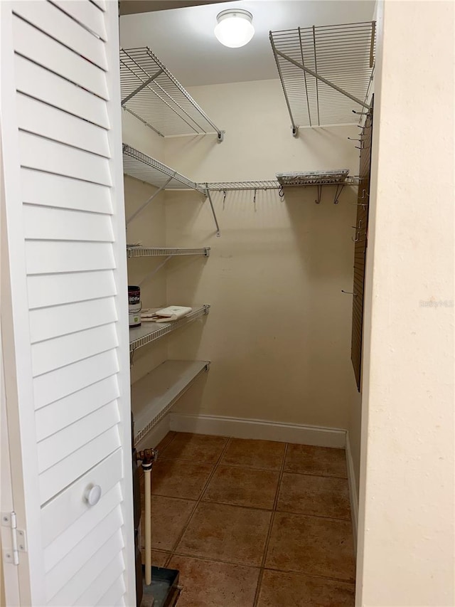 walk in closet with tile patterned flooring