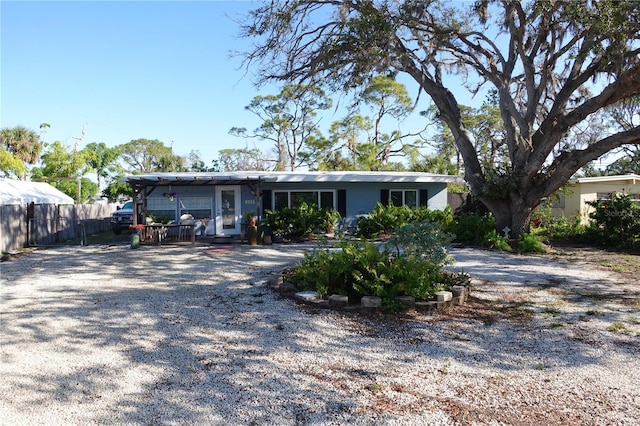 view of front of home featuring driveway and fence