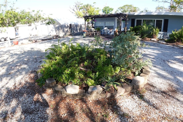 view of yard featuring fence and a pergola