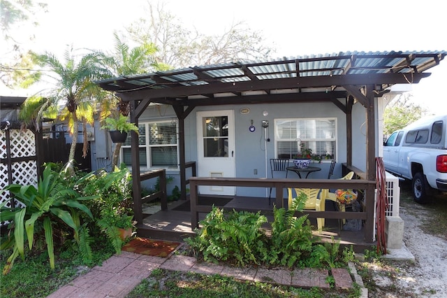 exterior space featuring stucco siding and a pergola