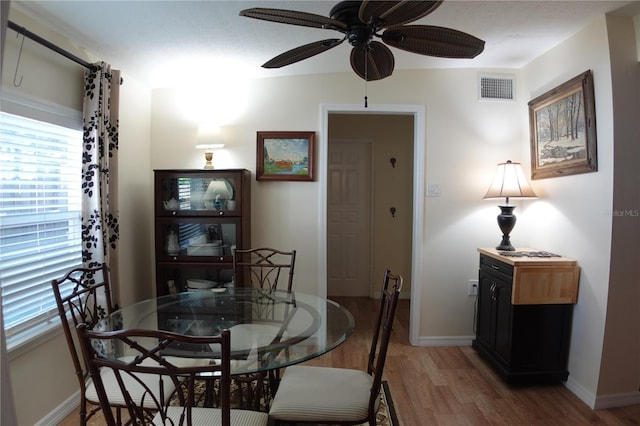 dining area featuring plenty of natural light, wood finished floors, visible vents, and ceiling fan