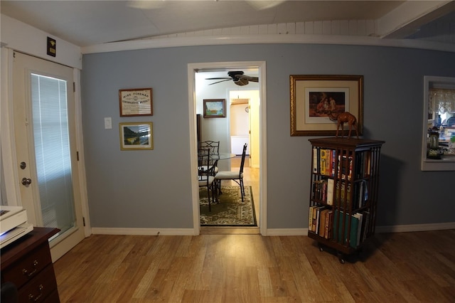 interior space featuring baseboards and light wood-style flooring