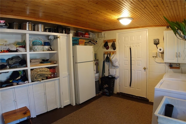 clothes washing area with laundry area, concrete block wall, wood ceiling, and washer / dryer